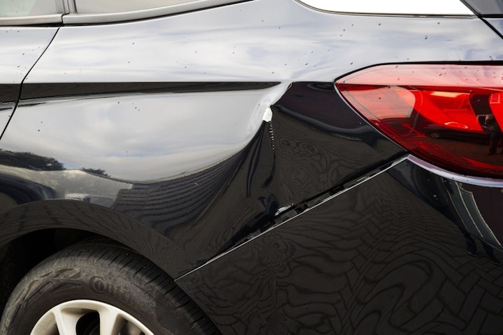 Deuk achterscherm Opel Astra